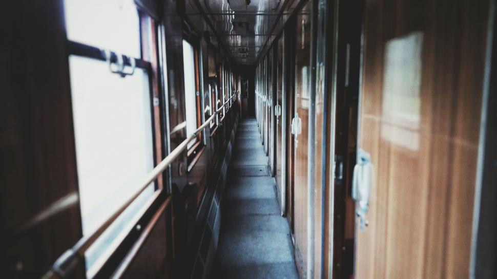 Free Image of Long Hallway With Clock on the Wall 