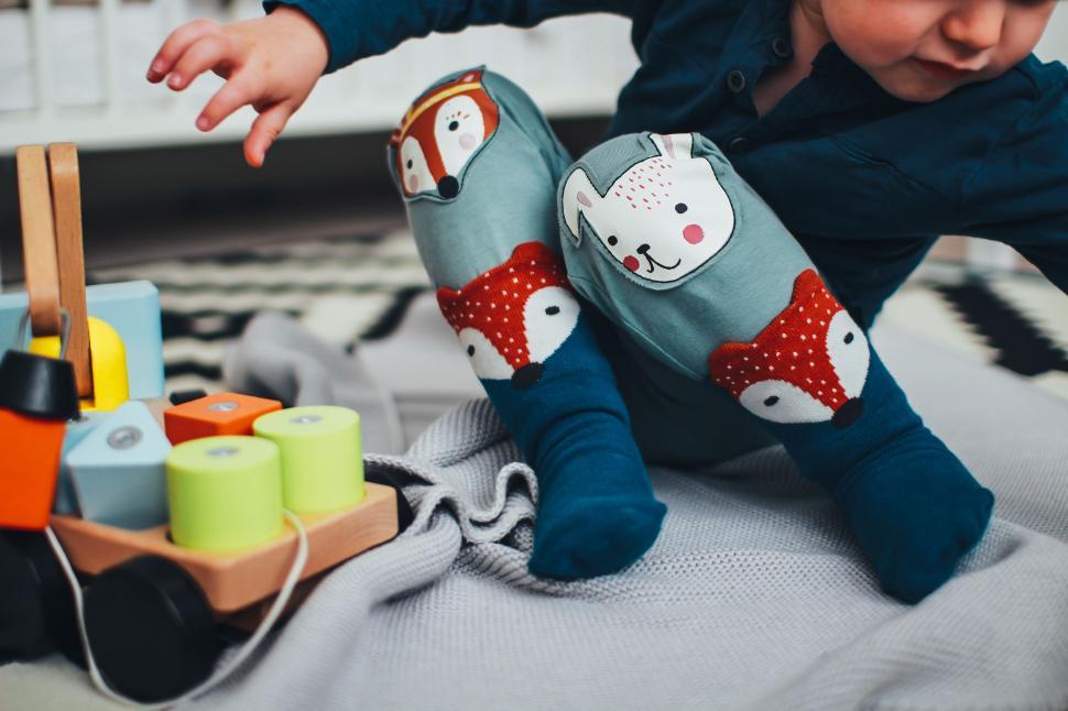 Free Image of Young Child Playing With Toys on the Floor 