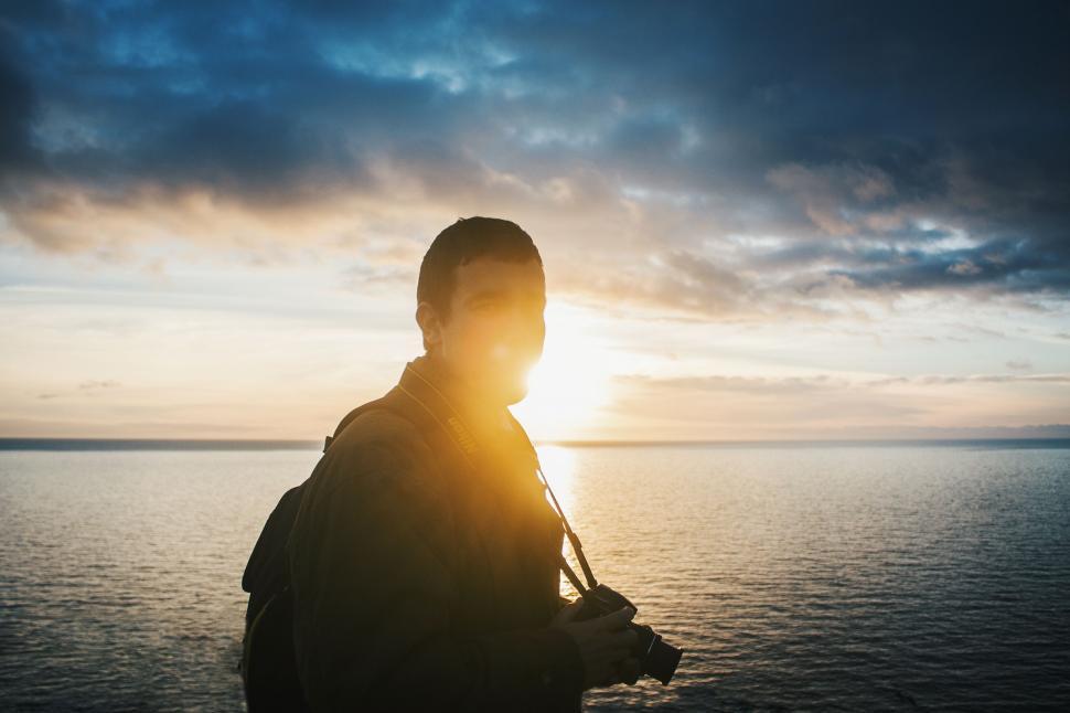 Free Image of Man Standing on Top of Boat Near Ocean 