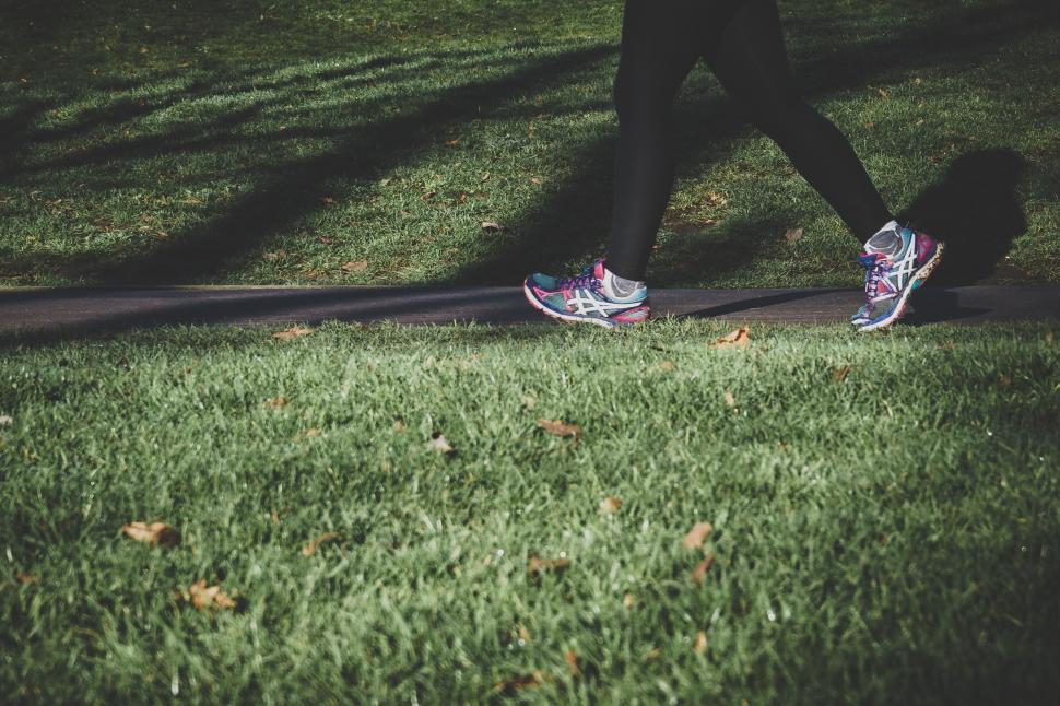 Free Image of Person Walking Across Lush Green Field 