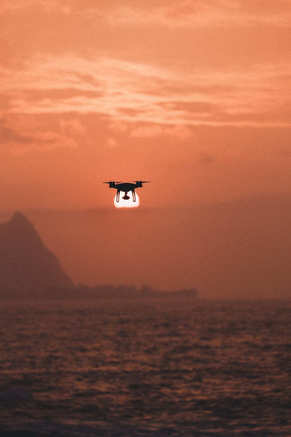 Free Image of Small Airplane Flying Over a Body of Water 