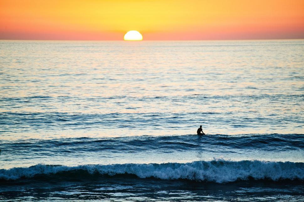 Free Image of Person Riding Surfboard on Ocean Wave 