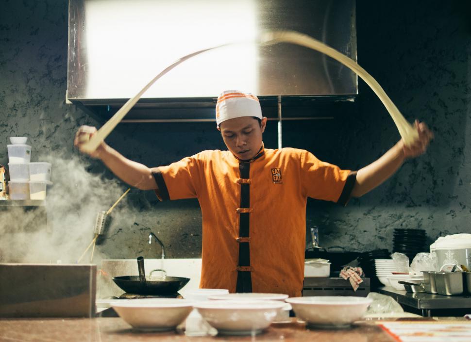 Free Image of Man in Orange Shirt and Tie in Kitchen 