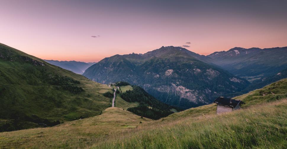 Free Image of Majestic Mountain Range Silhouetted Against Setting Sun 