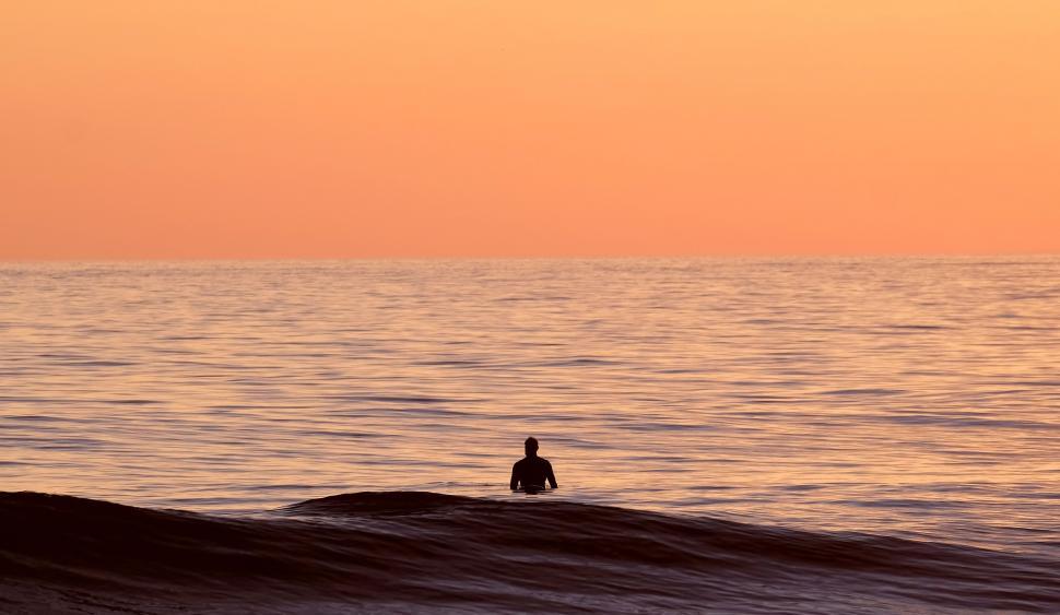 Free Image of Person Riding a Wave on Surfboard 
