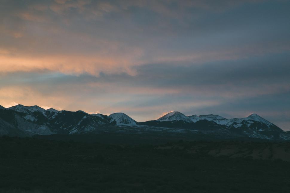 Free Image of Majestic Mountain Range Under a Cloudy Sky 