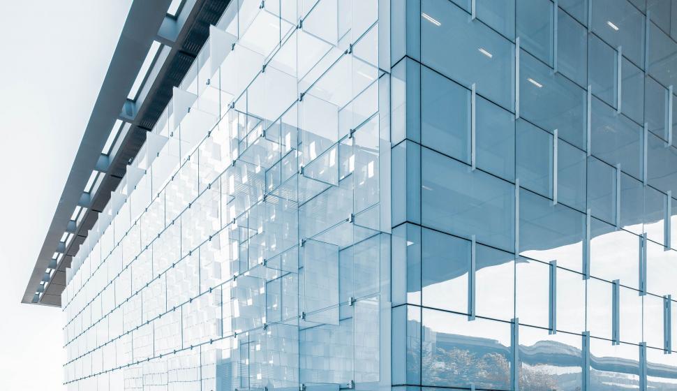 Free Image of Tall Building With Numerous Windows Next to Street 