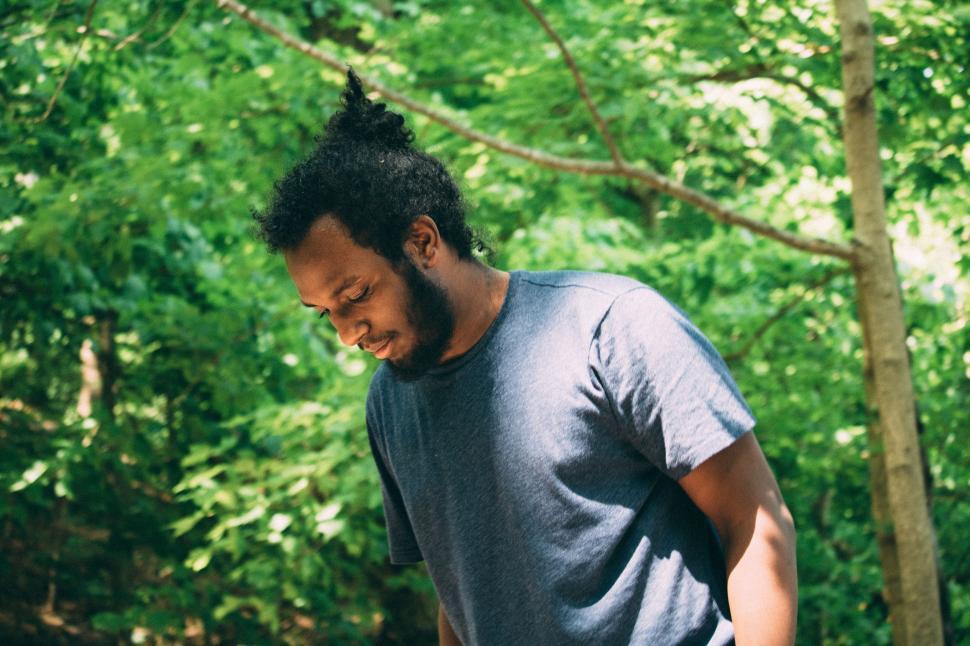 Free Image of Man Holding Frisbee in Forest Clearing 