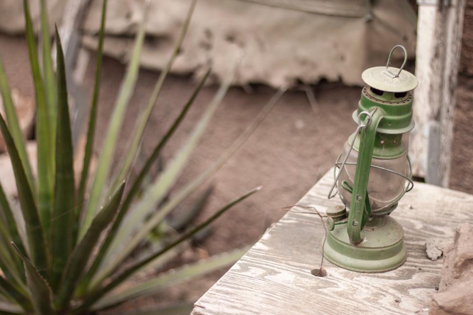 Free Image of Green Lantern on Wooden Table 