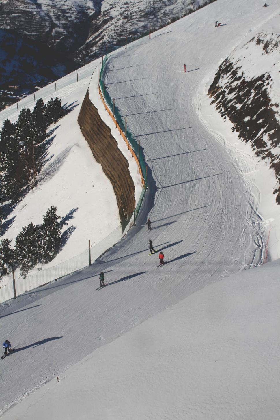 Free Image of Group of People Skiing Down Snowy Slope 