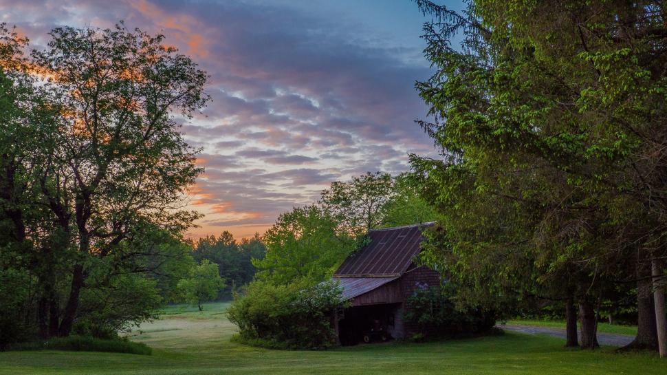 Free Image of A Barn in the Middle of a Grassy Field 