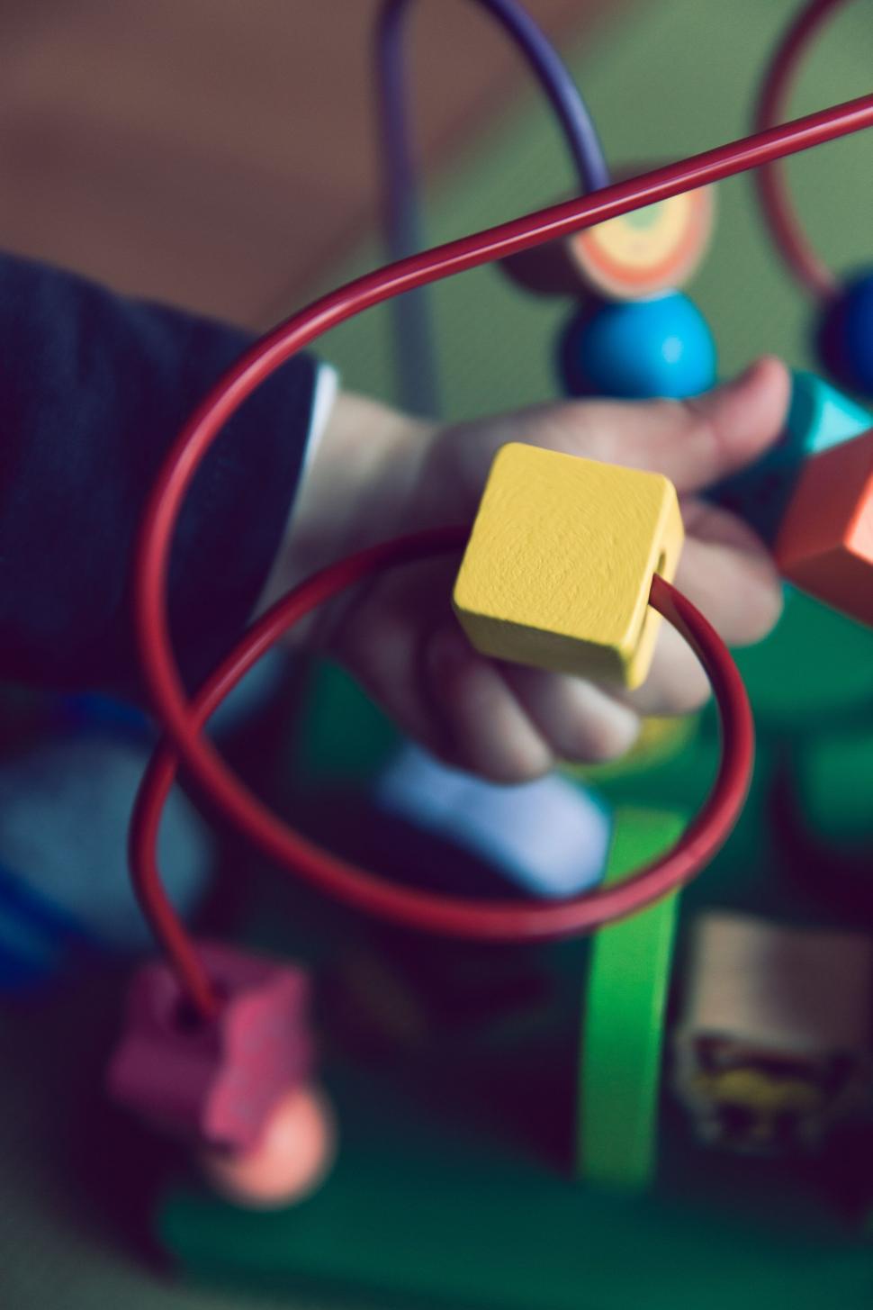 Free Image of Childs Hand Holding Wooden Block Toy 