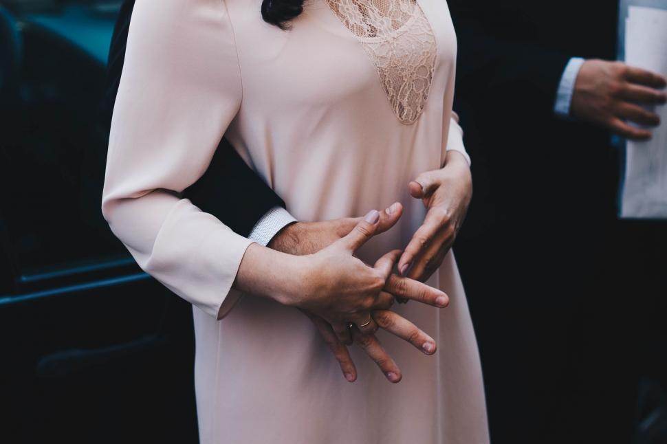 Free Image of Woman in Pink Dress Standing Next to Man in Suit 