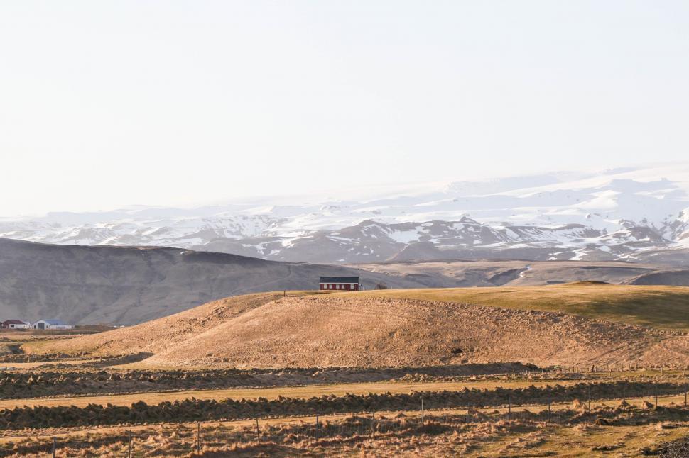 Free Image of Snow-Covered Mountains Rising Above Field 