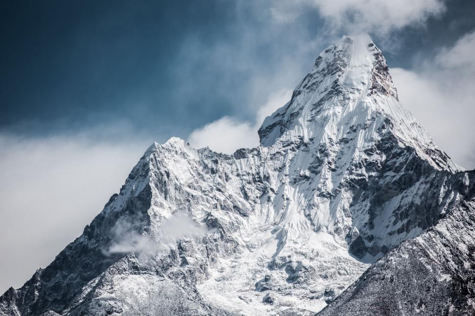 Free Image of Snow Covered Mountain With Clouds in the Sky 