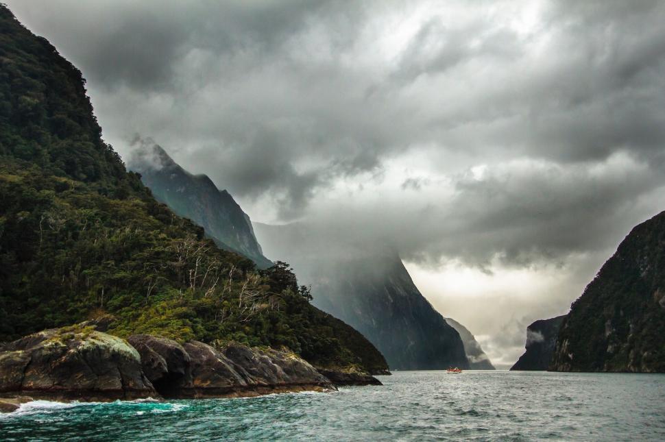 Free Image of Majestic Mountain Lake Under Cloudy Sky 