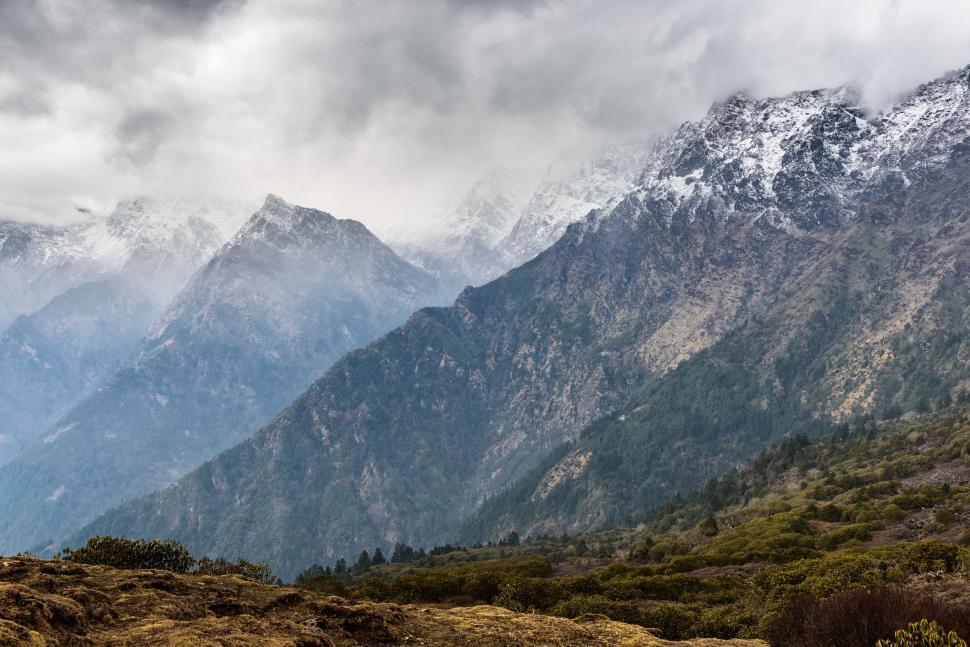 Free Image of Majestic Mountain Range Beneath Cloudy Sky 
