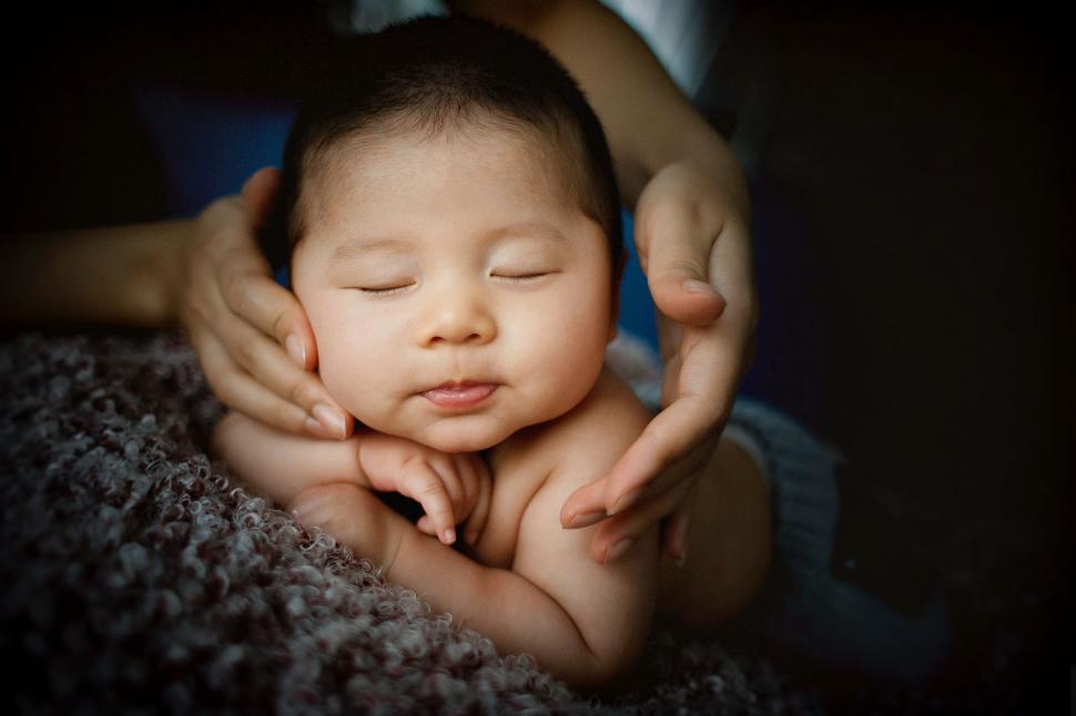Free Image of Woman Holding Baby in Her Arms 