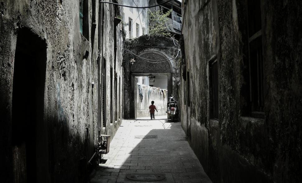 Free Image of Person Walking Down Narrow Alleyway 