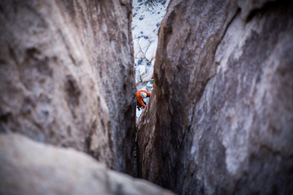 Free Image of Man Climbing Up the Side of a Mountain 