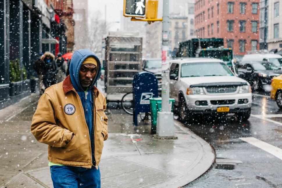 Free Image of Man Walking Down Snowy Street 
