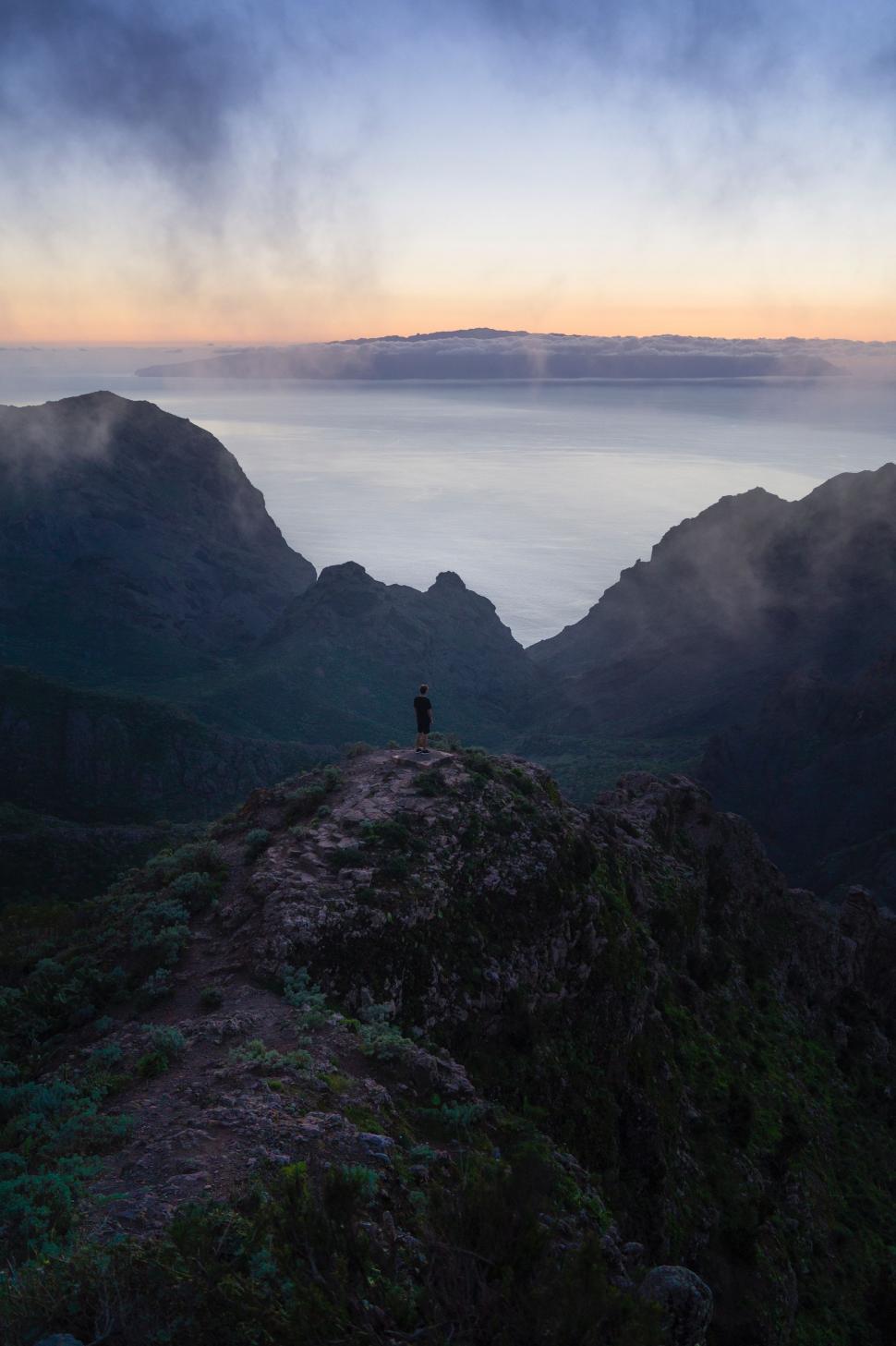 Free Image of Person Standing on Top of a Mountain 