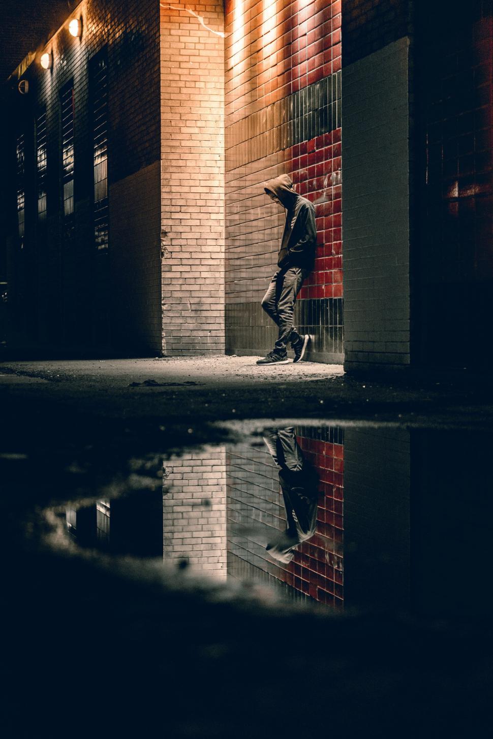 Free Image of Man Riding Skateboard Over Water Puddle 
