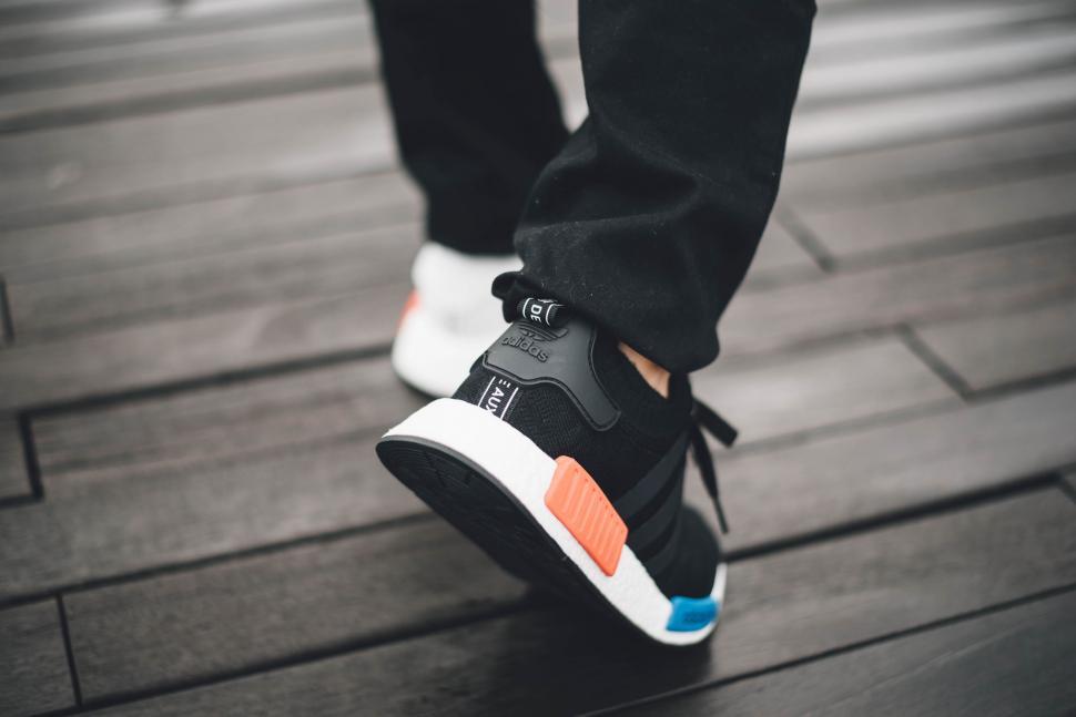 Free Image of Person in Black Pants and White Sneakers 