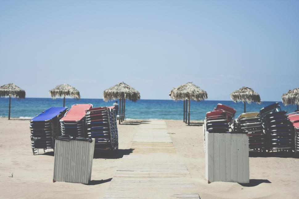 Free Image of Row of Beach Chairs on Sandy Beach 