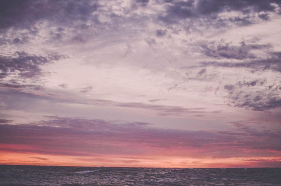 Free Image of Person Riding Surfboard on Body of Water 