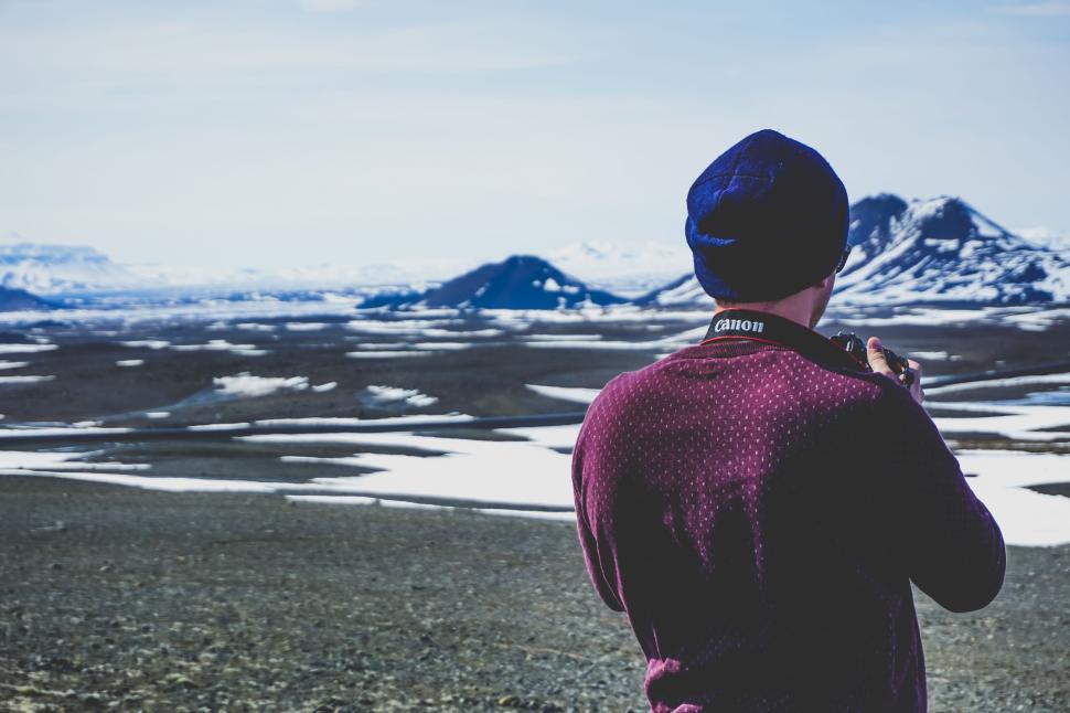 Free Image of Man Standing on Top of Snow Covered Field 