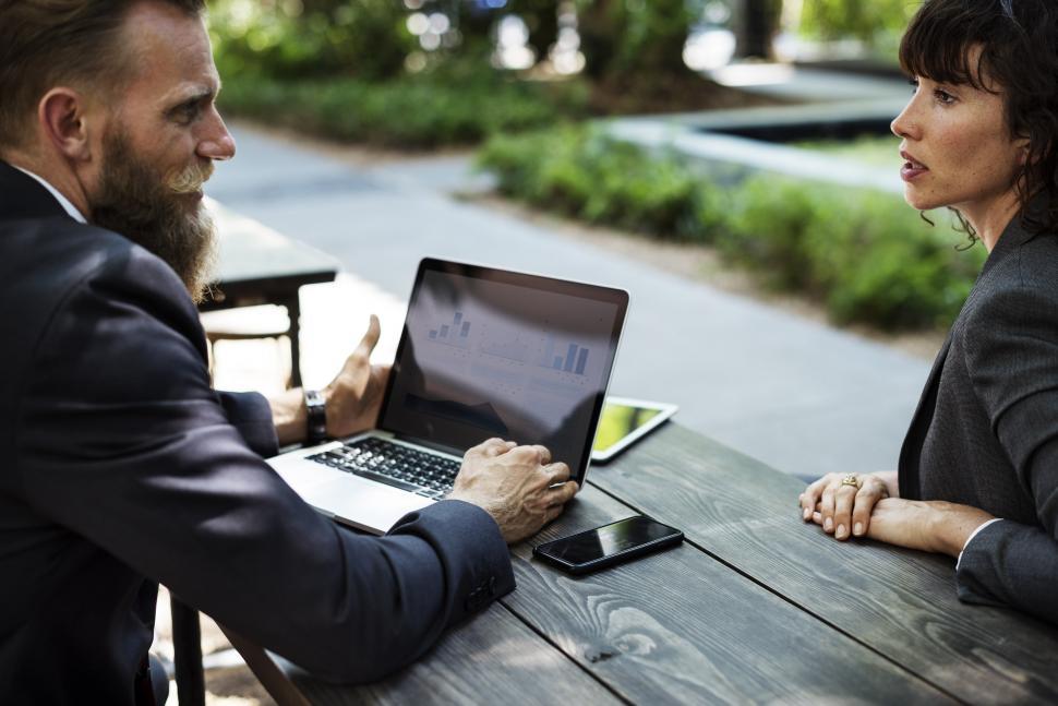 Free Image of Man and Woman Sitting at Table With Laptop 