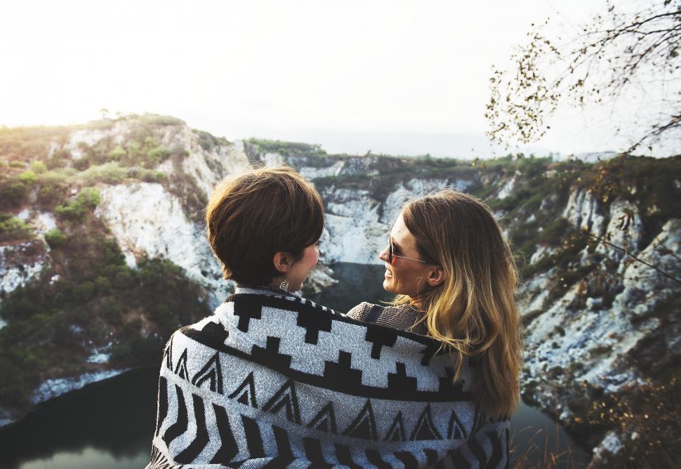Free Image of Couple Wrapped in Blanket Looking at Each Other 