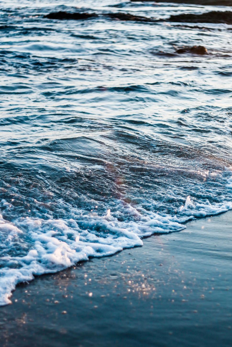 Free Image of Close Up of a Wave Crashing on a Beach 