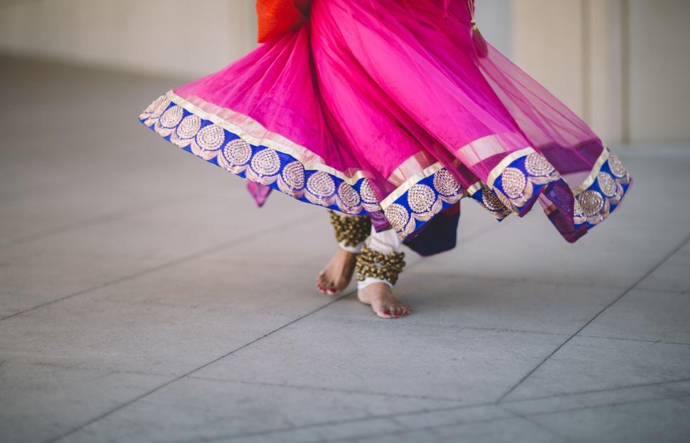 Free Image of Woman in a Pink and Blue Dress Dancing 