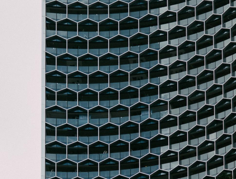 Free Image of Skyscraper With Numerous Windows Near Street Sign 