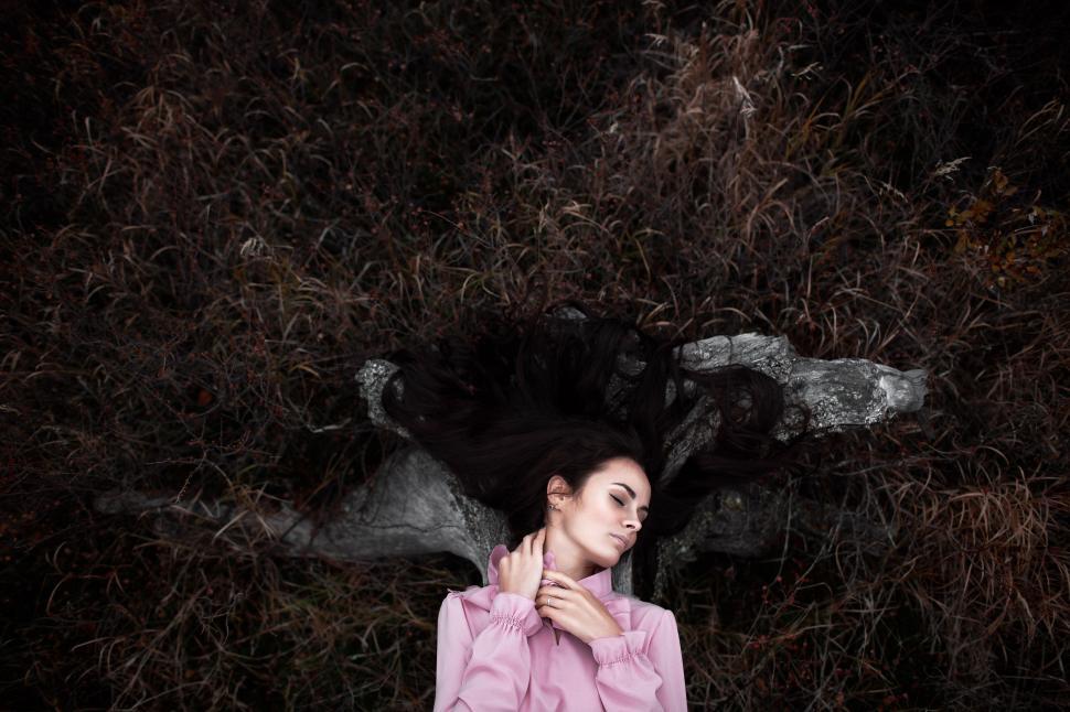 Free Image of Woman Standing in Front of Tree 