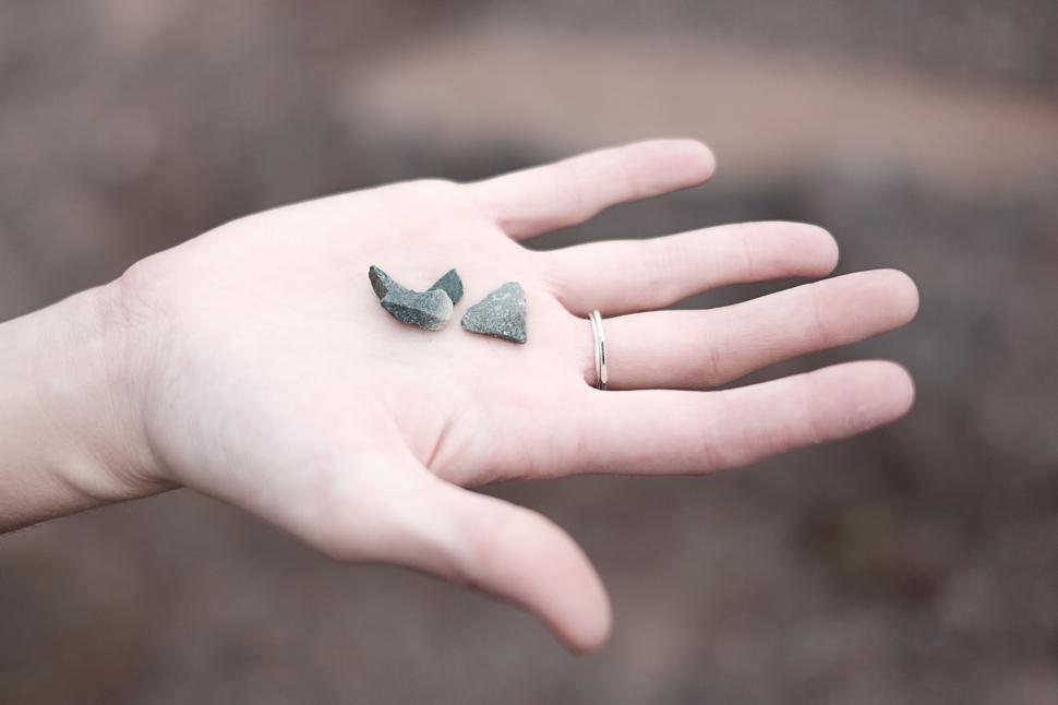 Free Image of A Persons Hand With a Pair of Earrings 