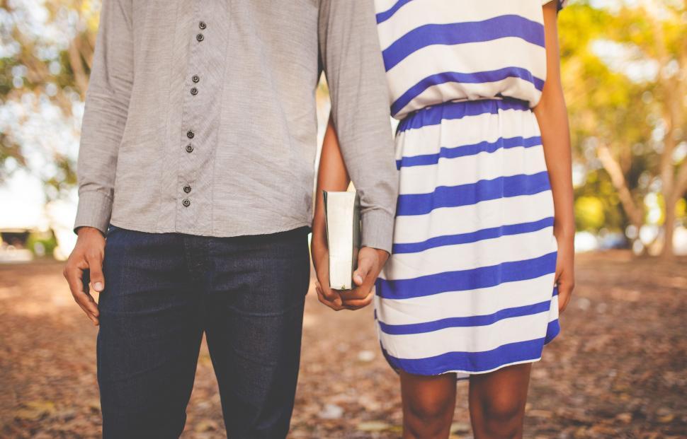 Free Image of A Man and a Woman Holding Hands 