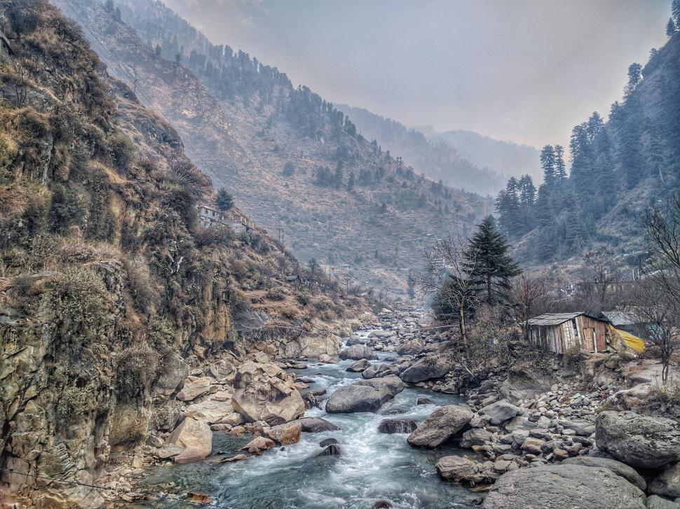 Free Image of River Flowing Through Rocky Mountain Side 