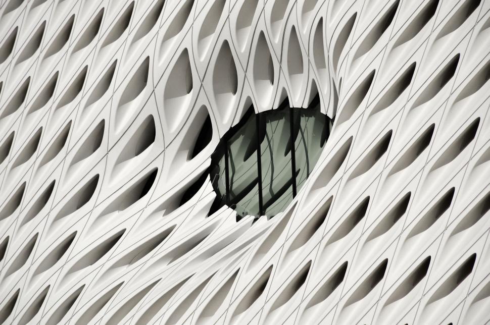 Free Image of Black Hole on Side of White Building 