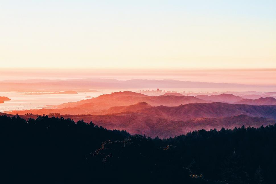 Free Image of Majestic Mountain Range Silhouetted Against Sunset Sky 