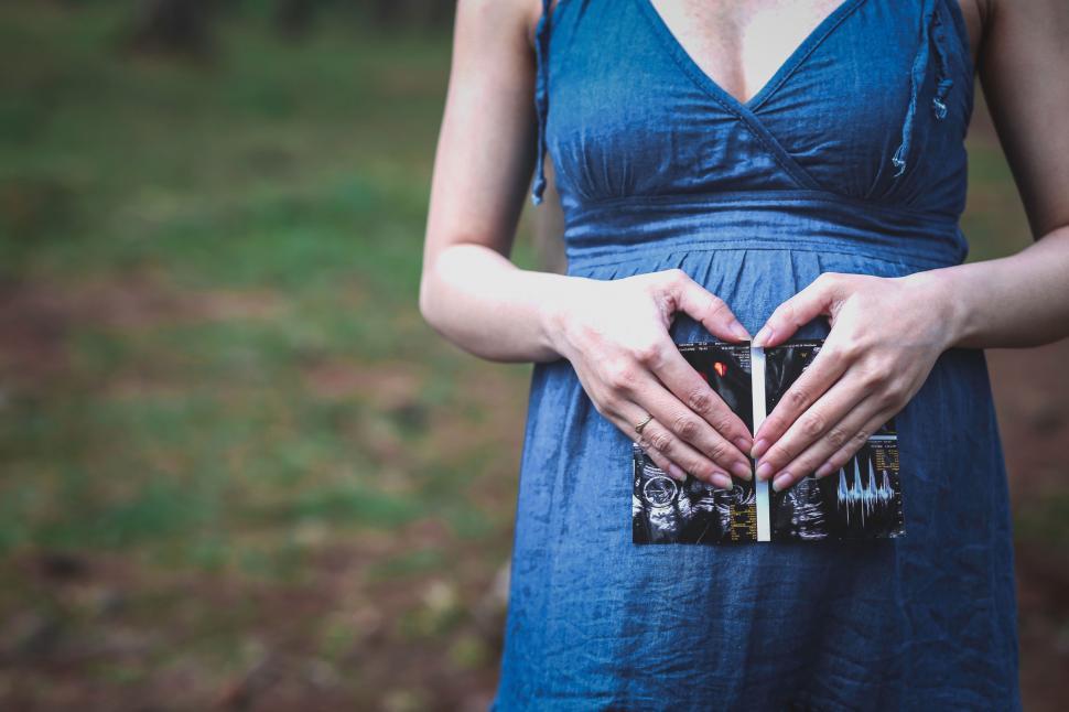 Free Image of Woman in Blue Dress Holding a Camera 