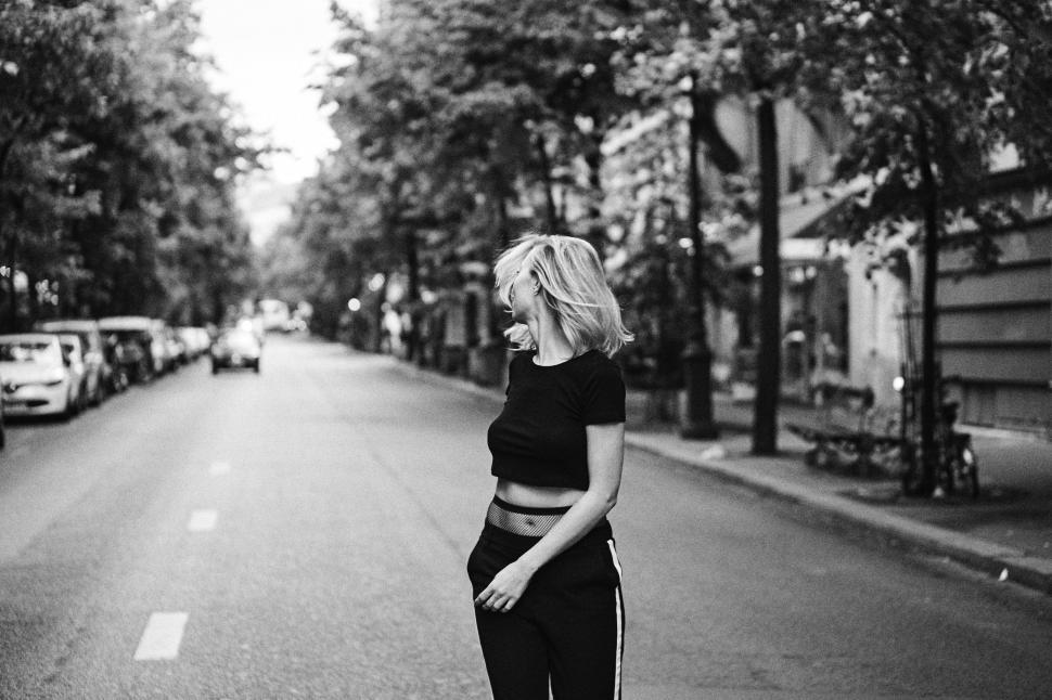 Free Image of Woman Standing in Middle of Street 