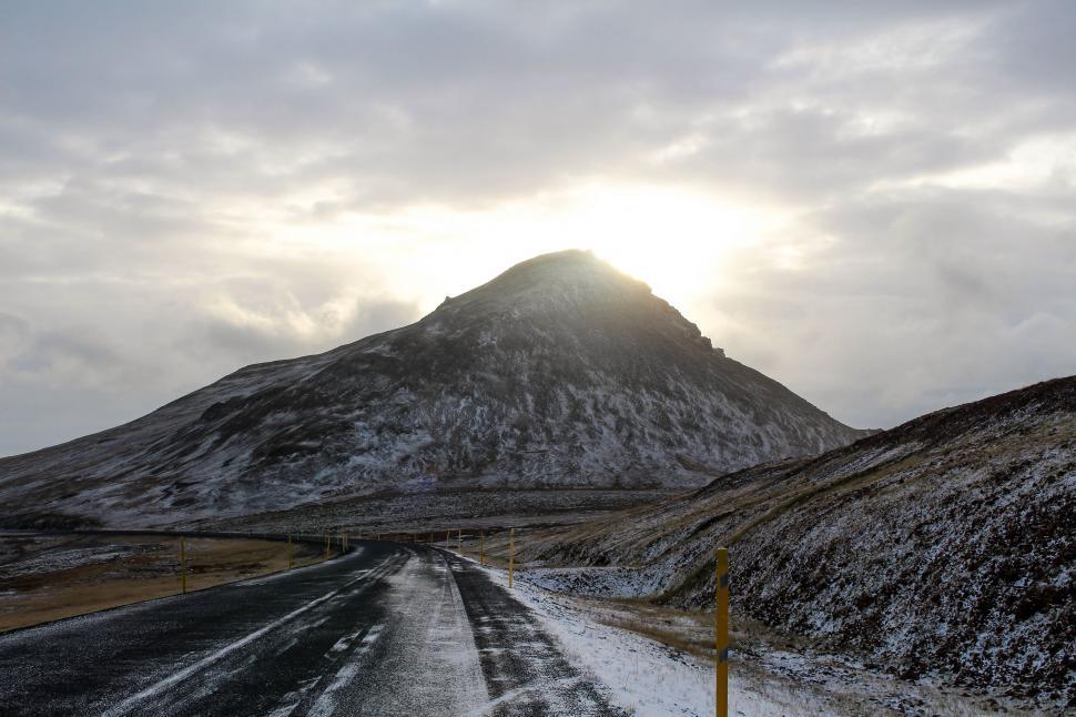 Free Image of Snow Covered Road With Mountain in Background 
