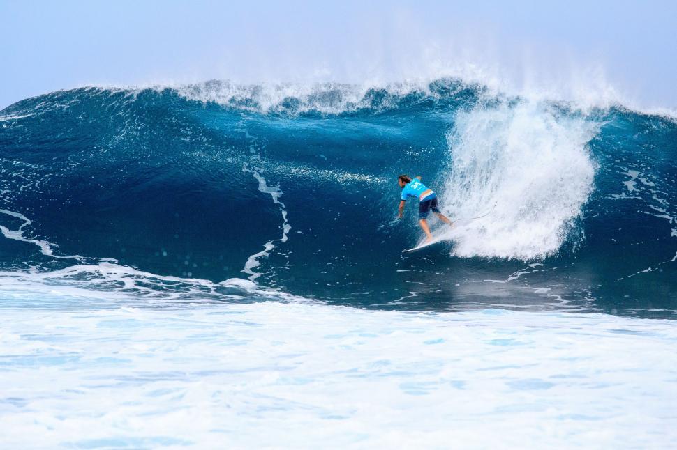 Free Image of Man Riding a Wave on Top of a Surfboard 
