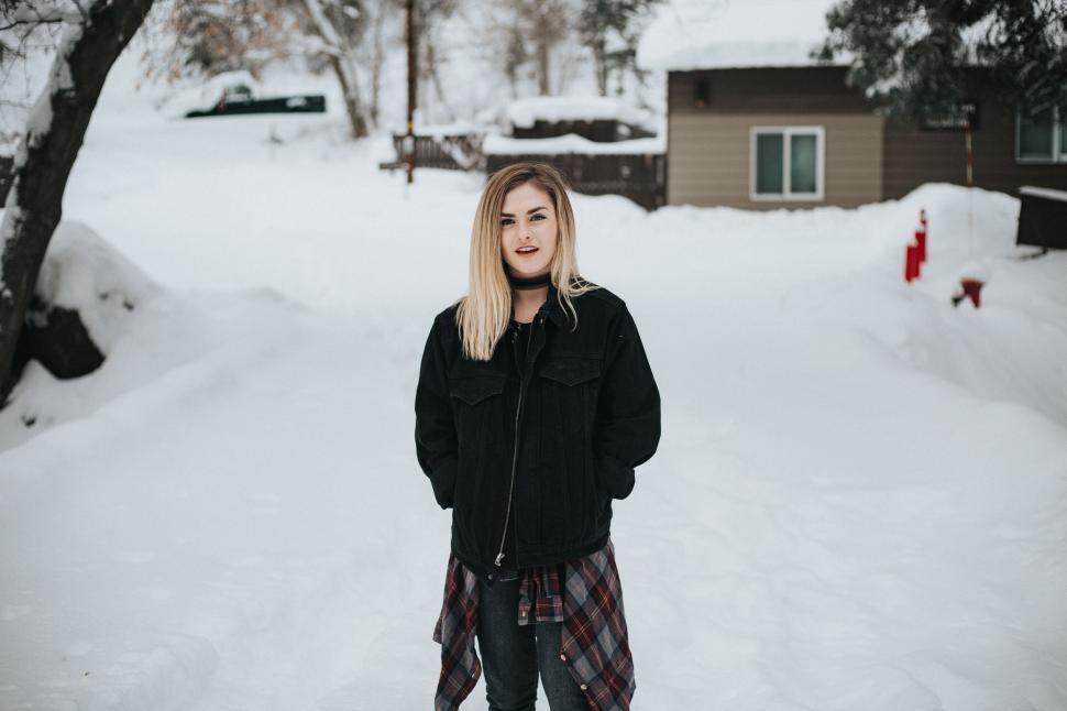 Free Image of Woman Standing in Snow Covered Road 