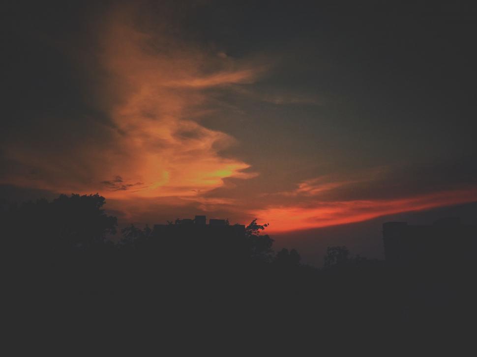 Free Image of Red Sky With Clouds and Trees 