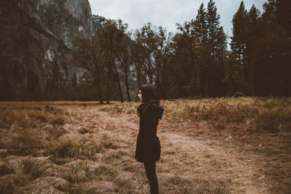 Free Image of Person Standing in Field With Mountain in Background 