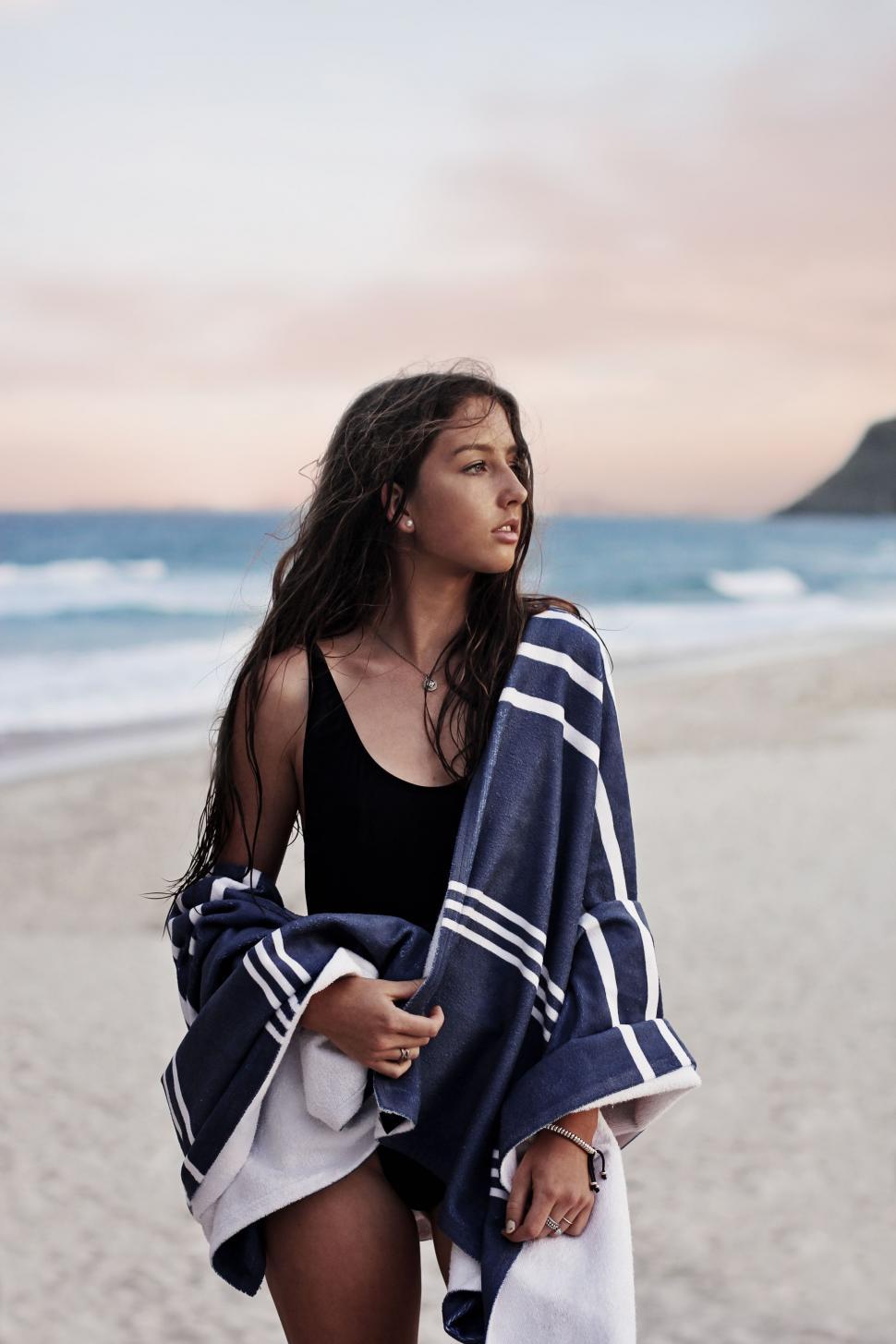 Free Image of Woman in Bathing Suit Standing on Beach 